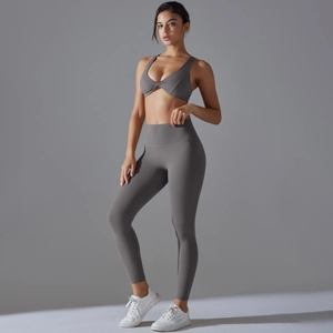 Detail view of high-waist yoga set with grey twisted sports bra and matching leggings