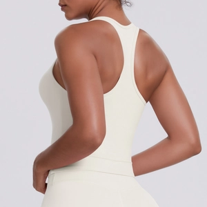 Close-up side view of cream racerback sports tank top showing seam detail and fit