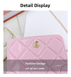 Detail of pink quilted PVC jelly bag featuring a gold camellia flower metal clasp