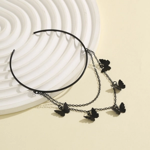 Detail of gothic black butterfly tassel arm cuff with layered chains and metal butterfly pendants
