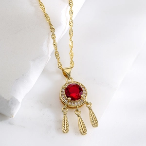 Elegant 18K gold plated necklace with red zircon pendant and feather charms on marble