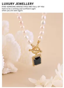 Macro view of natural freshwater pearl necklace with black zircon pendant and gold toggle clasp