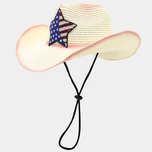 Detail of woven straw cowboy hat featuring American flag star patch and pink trim