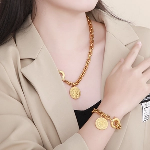 Fashionable gold chunky chain necklace and bracelet set with vintage coin pendants