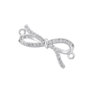 Macro shot of silver bow pendant featuring pave-set zircons and dual link rings