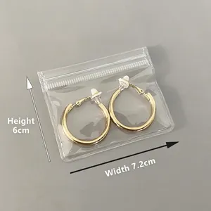 Golden round metal earrings in transparent PVC sealer bag, size 7.2cm by 6cm