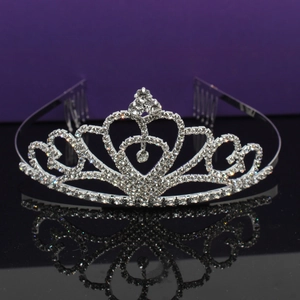 Elegant silver bridal tiara with rhinestones and heart design on reflective background