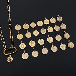 Gold-plated circular letter charms with crystal details and matching sun pendant necklace