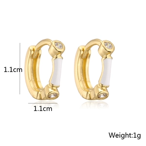 Detail shot of 18K gold-plated hoop earrings with white enamel and cubic zirconia stones