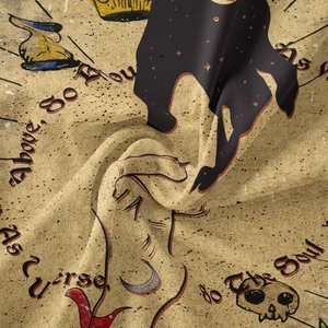 Detail of bohemian tapestry fabric showing vintage skull print and woven texture