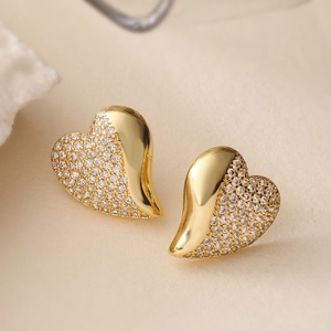 18K gold plated copper heart earrings with sparkling cubic zirconia on light texture