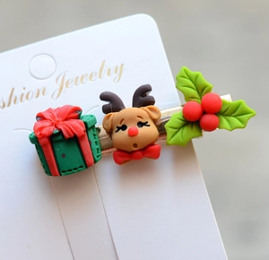 Detailed view of Christmas hair clip featuring reindeer and festive gift box elements