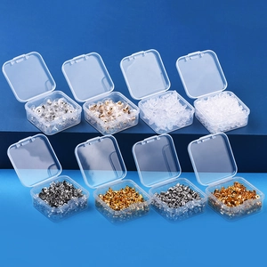 Eight plastic organizer boxes with gold, silver, and clear silicone earring backings
