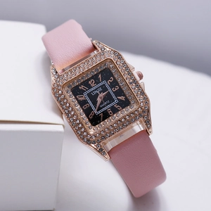 Detail of square rose gold watch with crystal bezel and pink leather strap