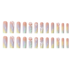 Long press-on nails with ombre pastel gradients, 3D white flowers, and pearl accents