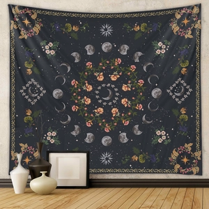 Detail of bohemian wall tapestry with celestial moon phases and floral sun patterns