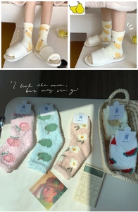 Detail of coral fleece winter socks with soft textures and cute fruit patterns
