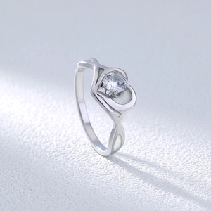 Macro shot of heart-shaped silver ring with polished 304 stainless steel and clear zircon