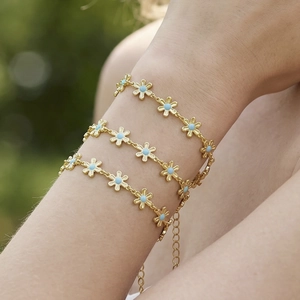 Three-piece gold plated stainless steel bracelet set with blue daisy charms for women