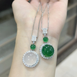 Close-up of elegant chalcedony pendant necklaces with green and white round gemstones