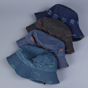 Detail view of colorful distressed holes and stitching on multi-color denim bucket hats
