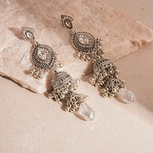 Detailed close-up of vintage silver Jhumka earrings with tassels and crystal rhinestones