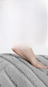 Close-up of soft grey microfiber bathroom mat with textured stripes and plush feel