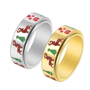 Detailed view of rotating gold and silver Christmas rings with reindeer and star motifs