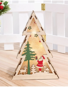 Detail of wooden Christmas tree LED ornament with warm glow and festive winter carvings