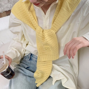Macro shot of yellow knit shawl featuring elegant cutout hollow texture and DD pattern