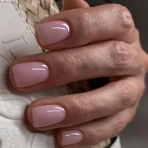Detail of pink glossy square press-on nails with semi-transparent jelly texture finish