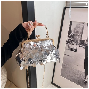 Detail of silver sequin crossbody bag with gold floral metal frame and chain strap