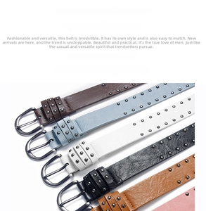 Detail of colorful leather belts featuring multiple metal round studs and silver buckles