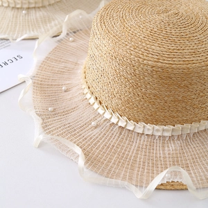 Women's summer straw hat with elegant white lace trim and pearl accents in French style