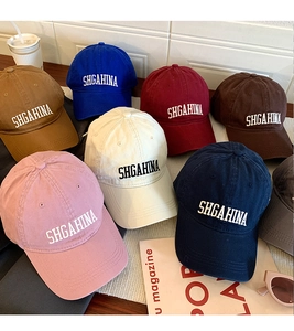 Detailed display of colorful baseball caps with letter embroidery in various shades