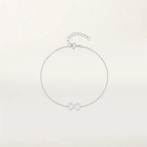 Close-up of S925 silver infinity bracelet with sparkling cubic zirconia on gray background