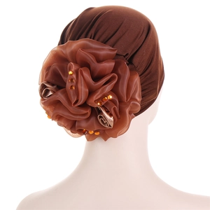 Detail of brown silk turban featuring layered handmade flowers and amber rhinestone accents