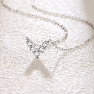 Elegant S925 silver V-shaped heart necklace with cubic zirconia on white background