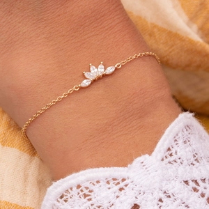 Detailed view of a gold-plated crown bracelet with five marquise-cut white zircons
