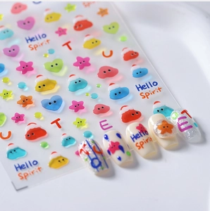Macro shot of cute cartoon nail stickers with colorful hearts and stars on nails