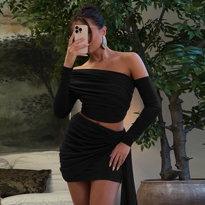 Detail of black off-shoulder long sleeve top and ruched bodycon skirt set fabric texture