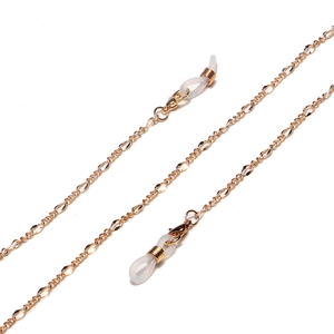 Detail of golden metal chain with lobster clasps and white rubber loops for glasses