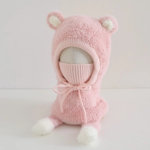 Close-up of pink plush bear ear hat featuring integrated knit face mask and drawstring