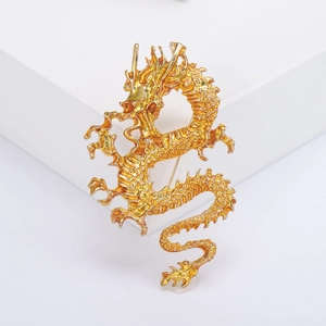 Detailed view of a golden Chinese dragon brooch featuring intricate scales and metal texture