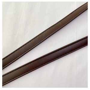 Detail view of dark brown faux leather shoulder straps with refined stitching and texture