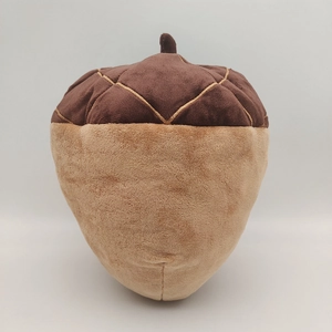 Macro shot of acorn plush toy with diamond grid stitching and brown velvet texture