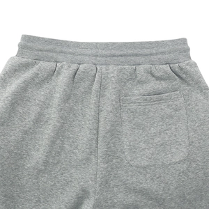 Detail view of grey joggers featuring high-quality cotton texture and back pocket stitching