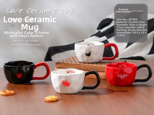 Detail of ceramic heart-shaped mug with Love pattern on dark wooden table with snacks
