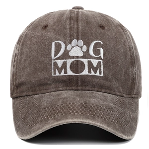 Detail of white DOG MOM embroidery and paw print on vintage washed brown cotton baseball cap