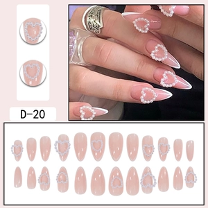 Almond French tip press-on nails with heart pearl design on soft pink base